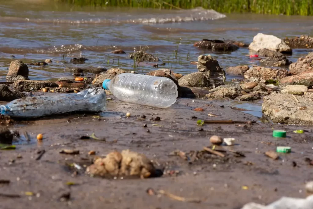 air yang tercemar dengan tanah dan botol plastik